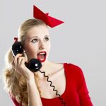 Beautiful fashion woman with a astonished expresion and holding a  vintage phone